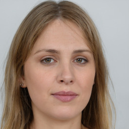 Joyful white young-adult female with long  brown hair and green eyes