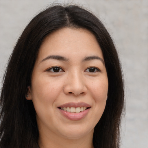 Joyful asian young-adult female with long  brown hair and brown eyes