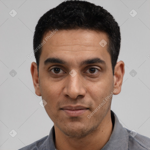 Joyful latino young-adult male with short  black hair and brown eyes