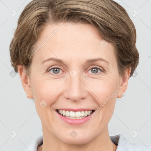 Joyful white adult female with short  brown hair and grey eyes