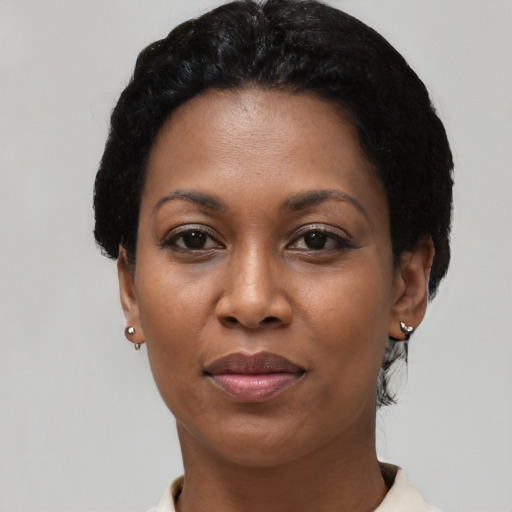 Joyful black adult female with short  black hair and brown eyes