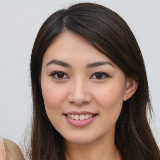 Joyful white young-adult female with long  brown hair and brown eyes