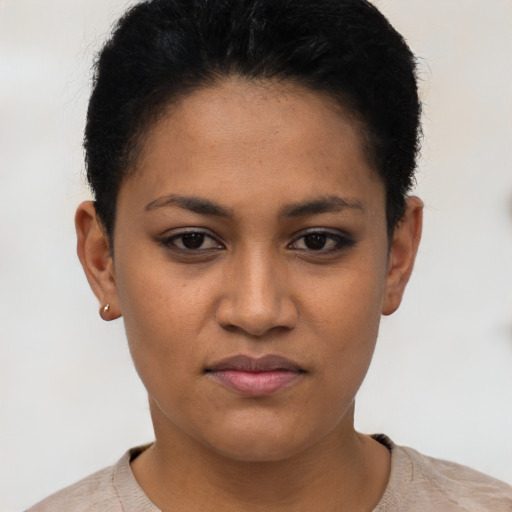 Joyful latino young-adult female with short  black hair and brown eyes