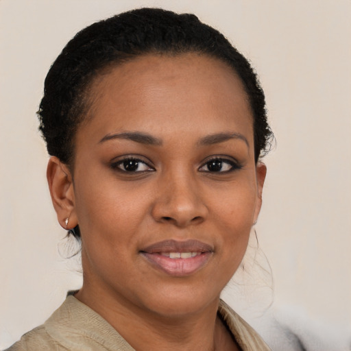 Joyful black young-adult female with short  brown hair and brown eyes