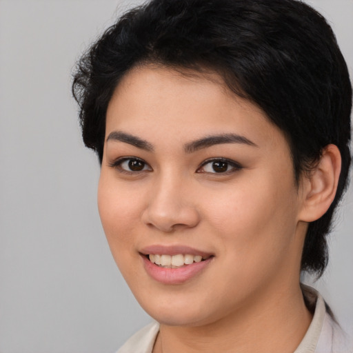Joyful white young-adult female with short  black hair and brown eyes