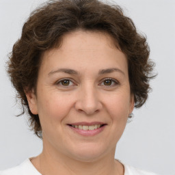 Joyful white adult female with short  brown hair and brown eyes