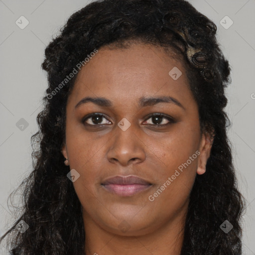 Joyful black young-adult female with long  black hair and brown eyes