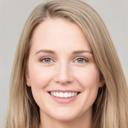 Joyful white young-adult female with long  brown hair and grey eyes