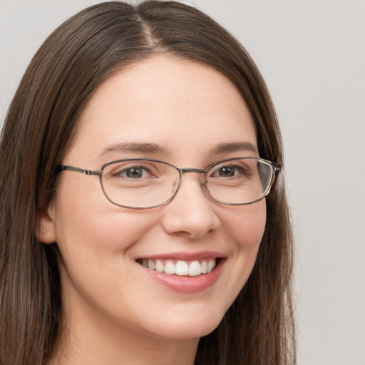 Joyful white young-adult female with long  brown hair and grey eyes