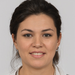 Joyful white young-adult female with medium  brown hair and brown eyes