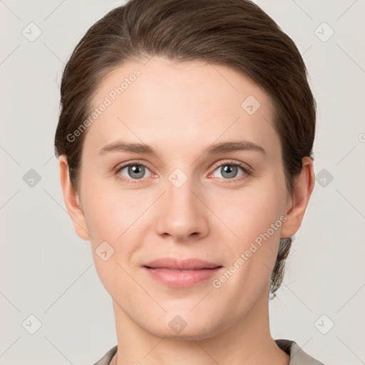 Joyful white young-adult female with short  brown hair and grey eyes