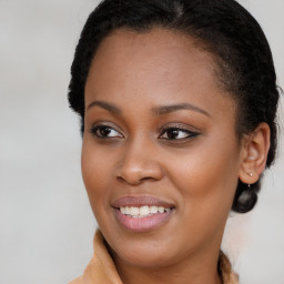 Joyful black young-adult female with long  brown hair and brown eyes