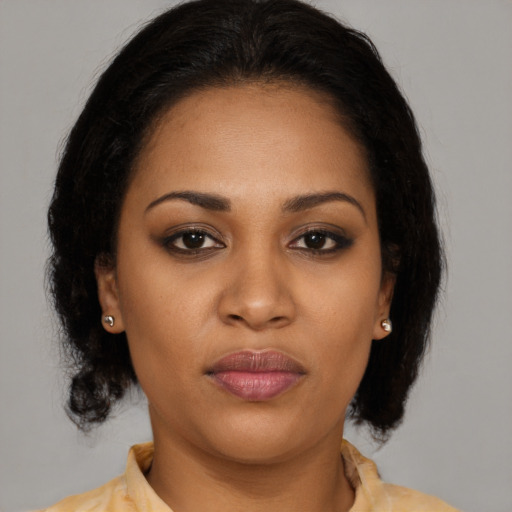 Joyful black young-adult female with medium  brown hair and brown eyes