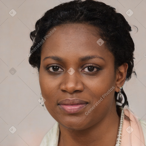 Joyful black young-adult female with long  black hair and brown eyes