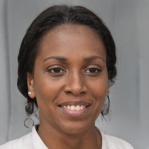 Joyful black young-adult female with medium  brown hair and brown eyes