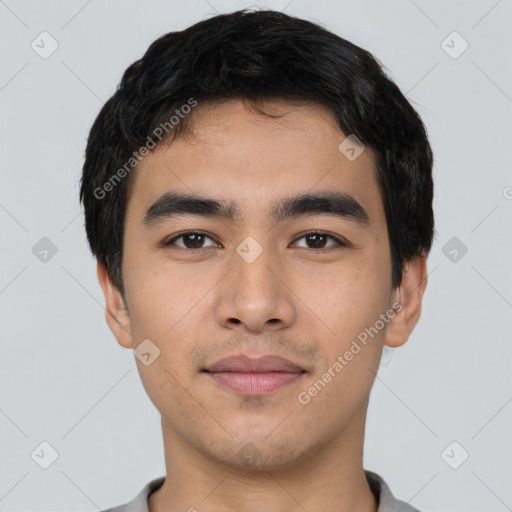 Joyful asian young-adult male with short  black hair and brown eyes