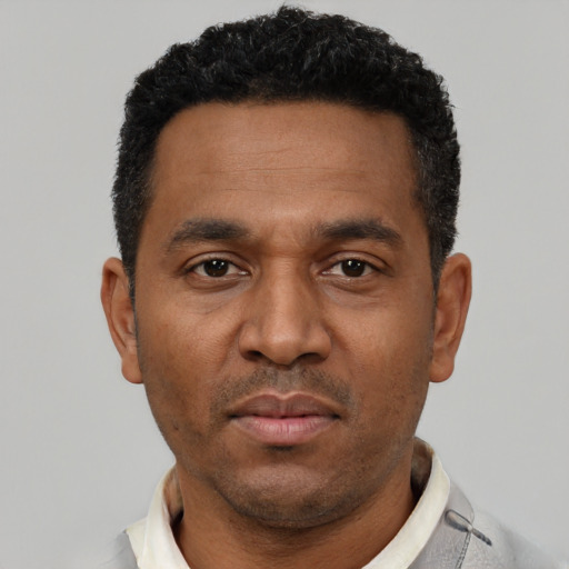 Neutral latino adult male with short  black hair and brown eyes