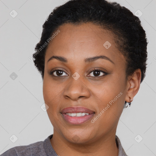 Joyful black young-adult female with short  brown hair and brown eyes