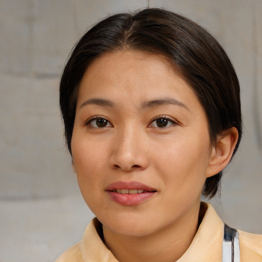 Joyful asian young-adult female with medium  brown hair and brown eyes