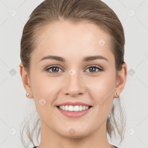 Joyful white young-adult female with medium  brown hair and grey eyes