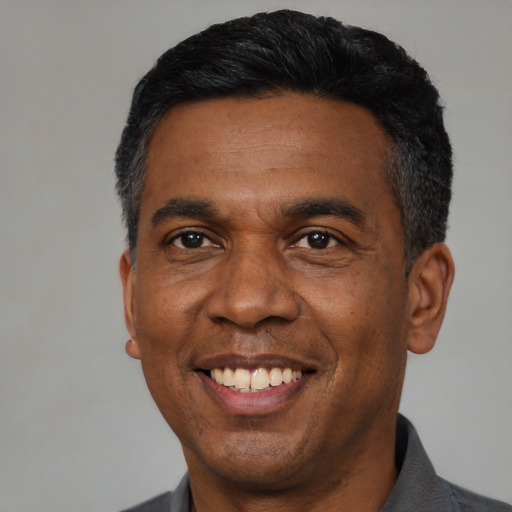 Joyful latino adult male with short  black hair and brown eyes