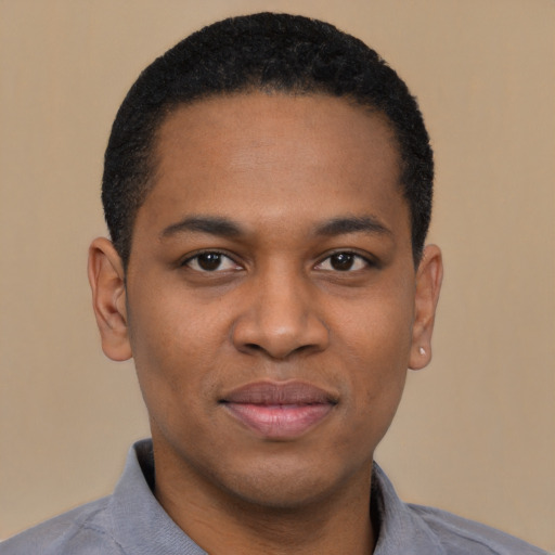 Joyful black young-adult male with short  black hair and brown eyes