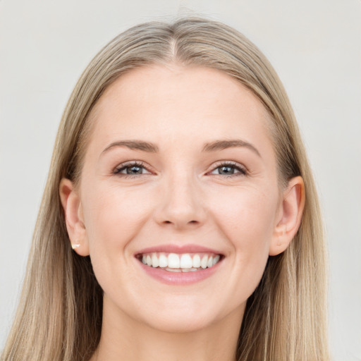 Joyful white young-adult female with long  brown hair and grey eyes