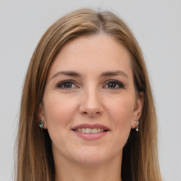 Joyful white young-adult female with long  brown hair and grey eyes