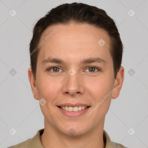 Joyful white young-adult male with short  brown hair and grey eyes