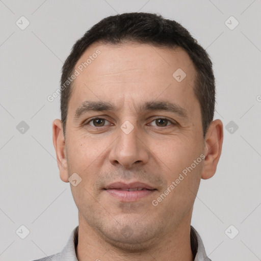 Joyful white adult male with short  brown hair and brown eyes