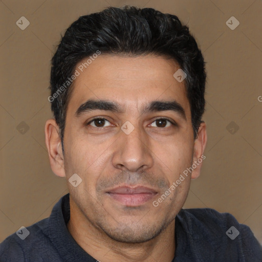 Joyful white adult male with short  black hair and brown eyes