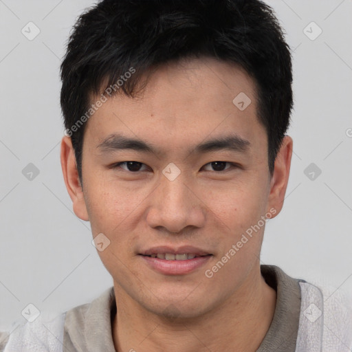 Joyful asian young-adult male with short  black hair and brown eyes