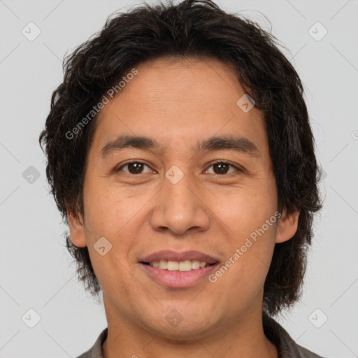 Joyful latino adult male with short  brown hair and brown eyes