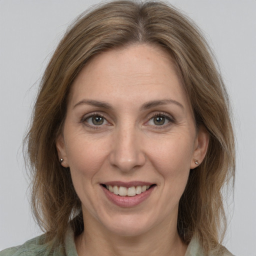 Joyful white adult female with medium  brown hair and grey eyes