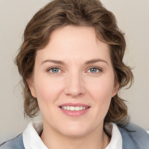 Joyful white young-adult female with medium  brown hair and blue eyes