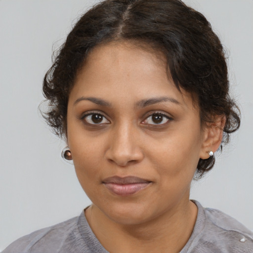 Joyful black young-adult female with medium  brown hair and brown eyes