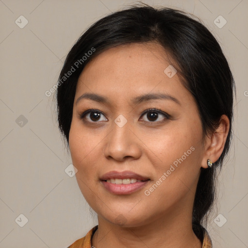 Joyful latino young-adult female with medium  brown hair and brown eyes