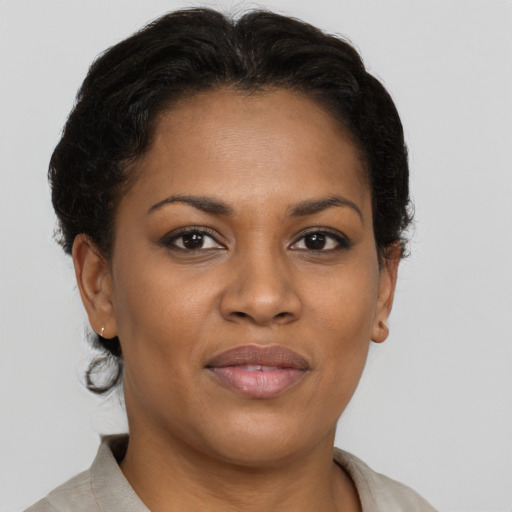 Joyful black adult female with short  brown hair and brown eyes