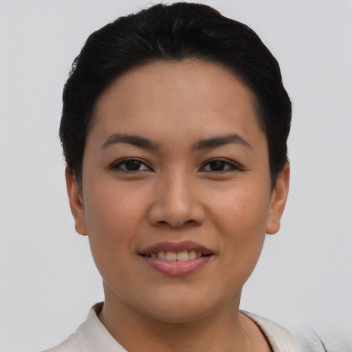 Joyful asian young-adult female with short  black hair and brown eyes