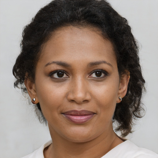 Joyful black young-adult female with medium  brown hair and brown eyes