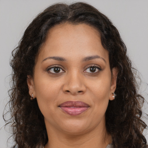 Joyful black adult female with medium  brown hair and brown eyes