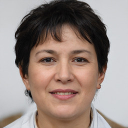 Joyful white adult female with short  brown hair and brown eyes