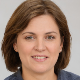 Joyful white adult female with medium  brown hair and grey eyes