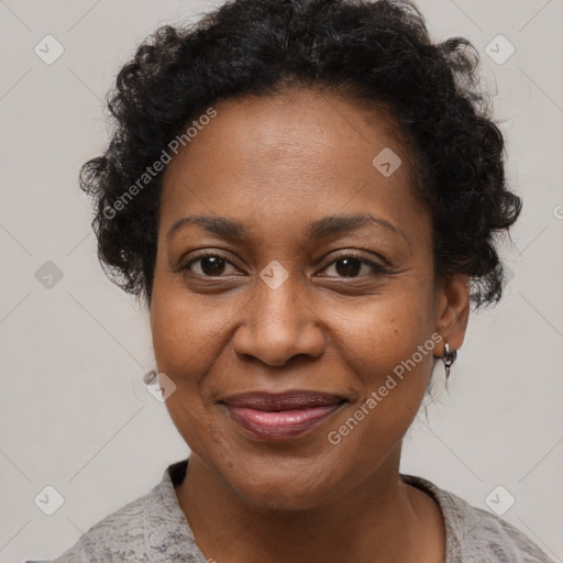 Joyful black adult female with short  brown hair and brown eyes