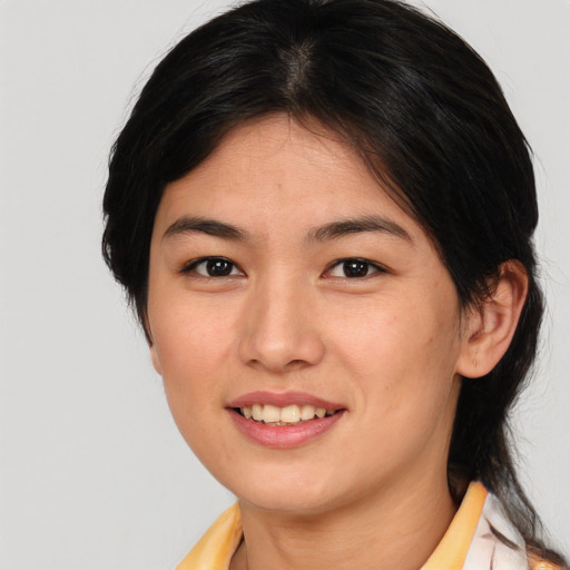 Joyful asian young-adult female with medium  brown hair and brown eyes