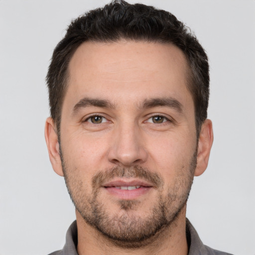 Joyful white young-adult male with short  brown hair and brown eyes