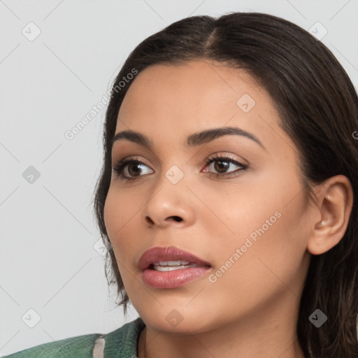 Joyful latino young-adult female with medium  brown hair and brown eyes