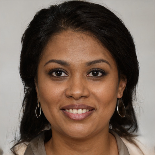Joyful black young-adult female with medium  brown hair and brown eyes