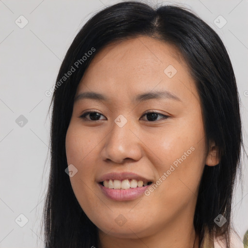 Joyful asian young-adult female with long  brown hair and brown eyes