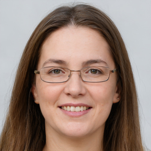 Joyful white adult female with long  brown hair and grey eyes